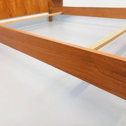 Double bed vintage modernist in teak and black metal from the 1960s with bedside tables.