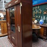 Empire style mahogany display bookcase with gilt bronze decoration and three doors.