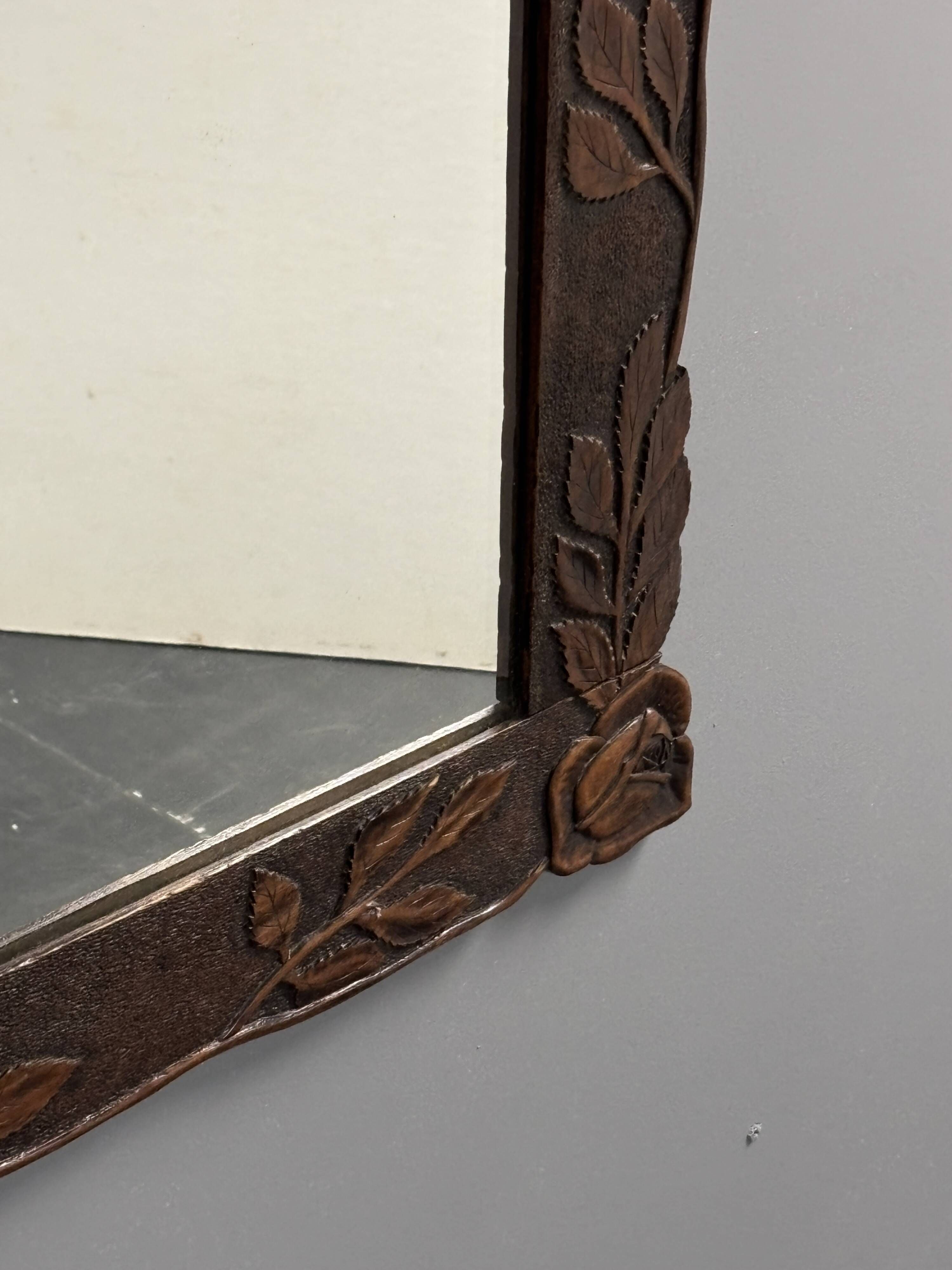 Arts & Crafts hand-carved wall mirror with floral roses, early 20th century