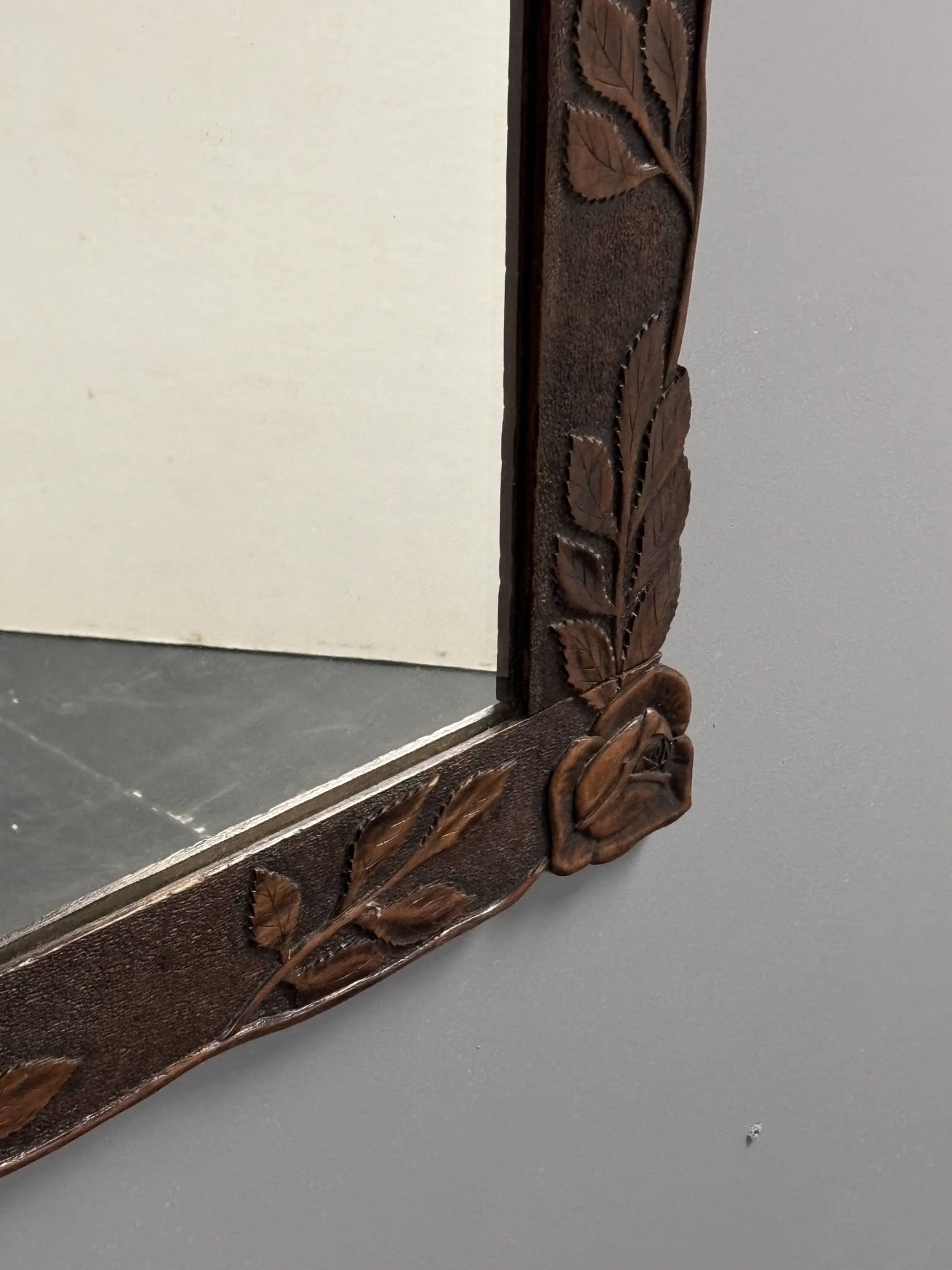 Arts & Crafts hand-carved wall mirror with floral roses, early 20th century