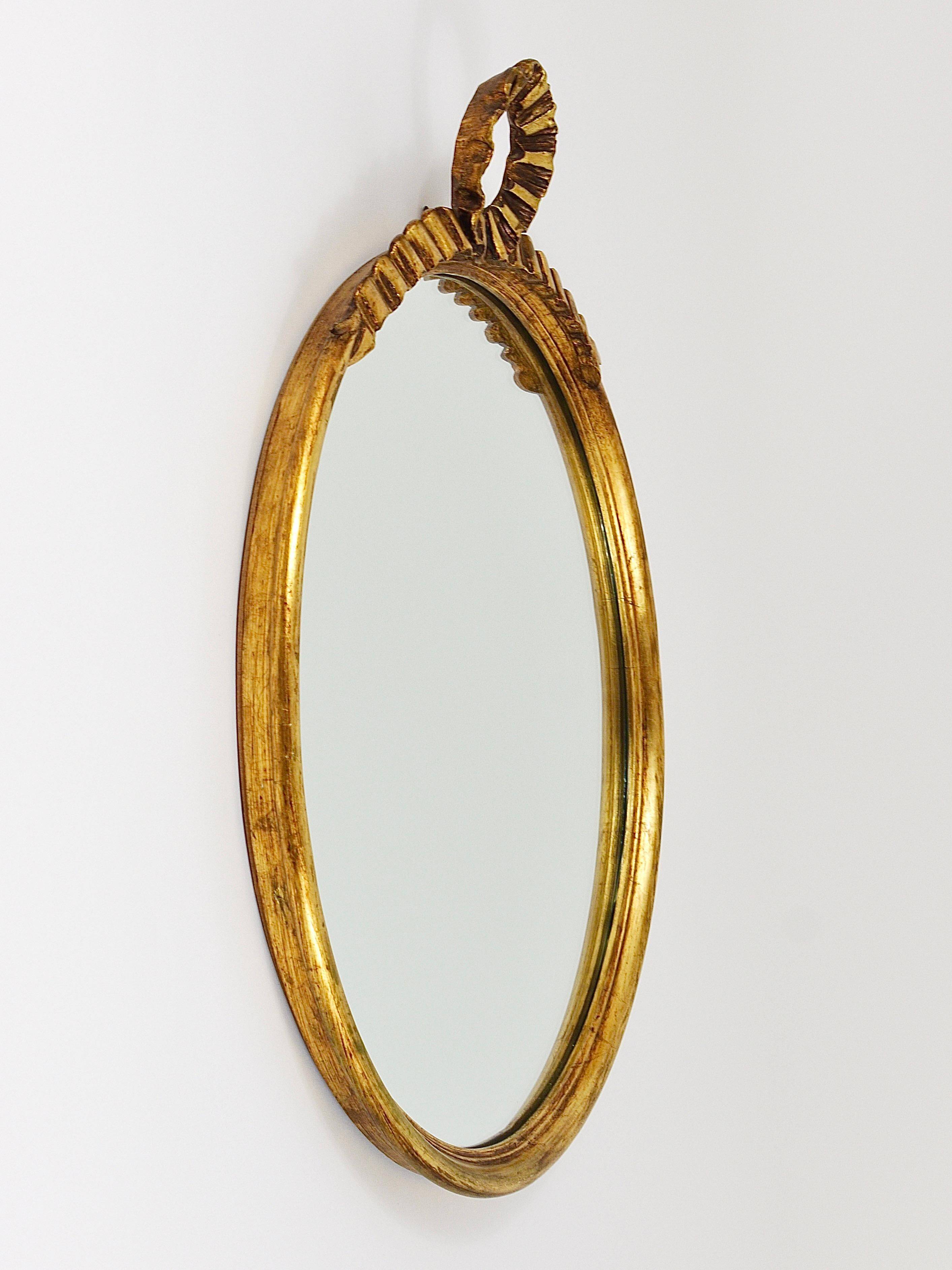 Round wall mirror in gilded wood, mid-century, C. Allodi & G. Subelli, Italy, 1950s.