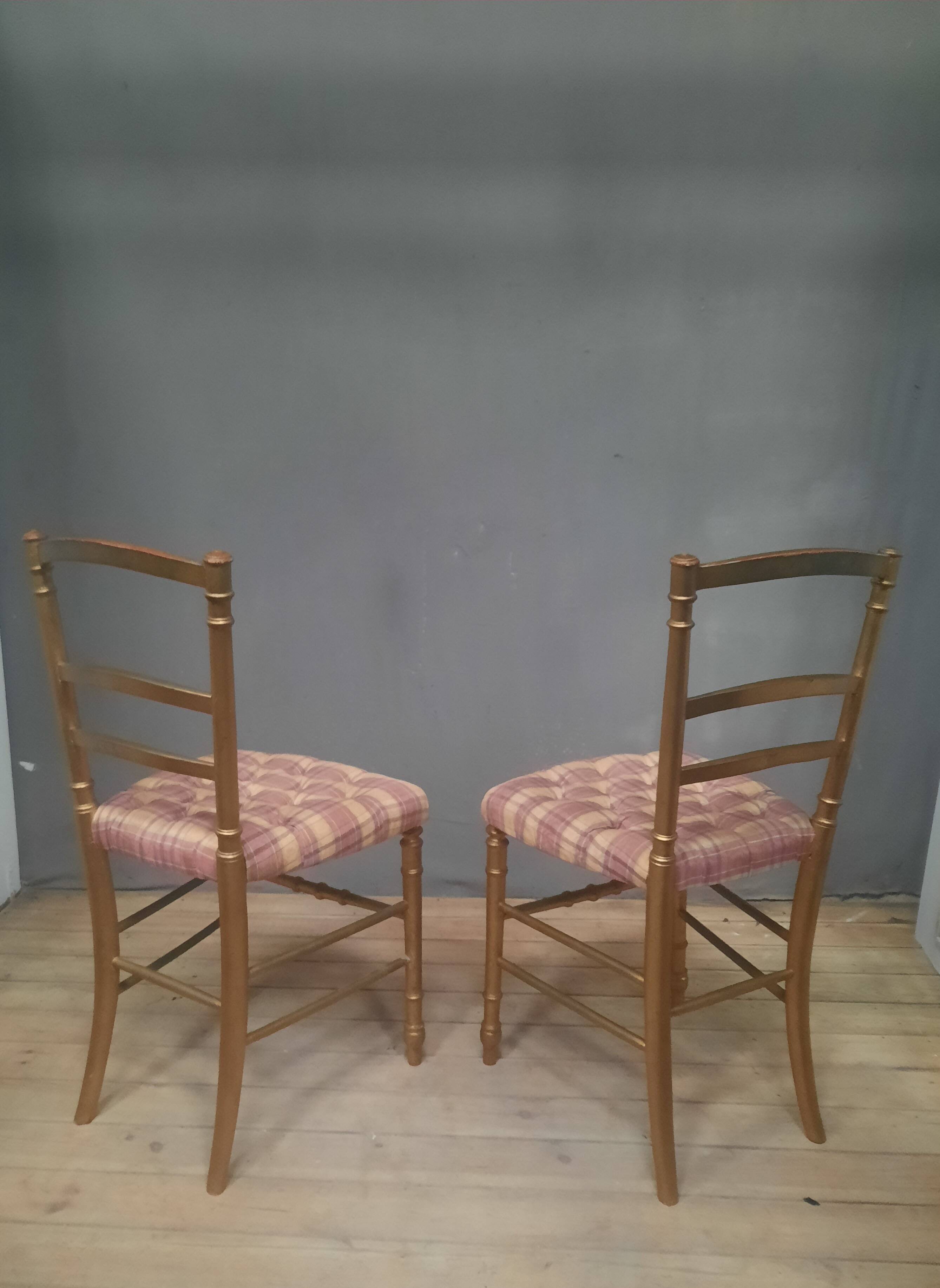 Pair of upholstered chairs in gilded wood