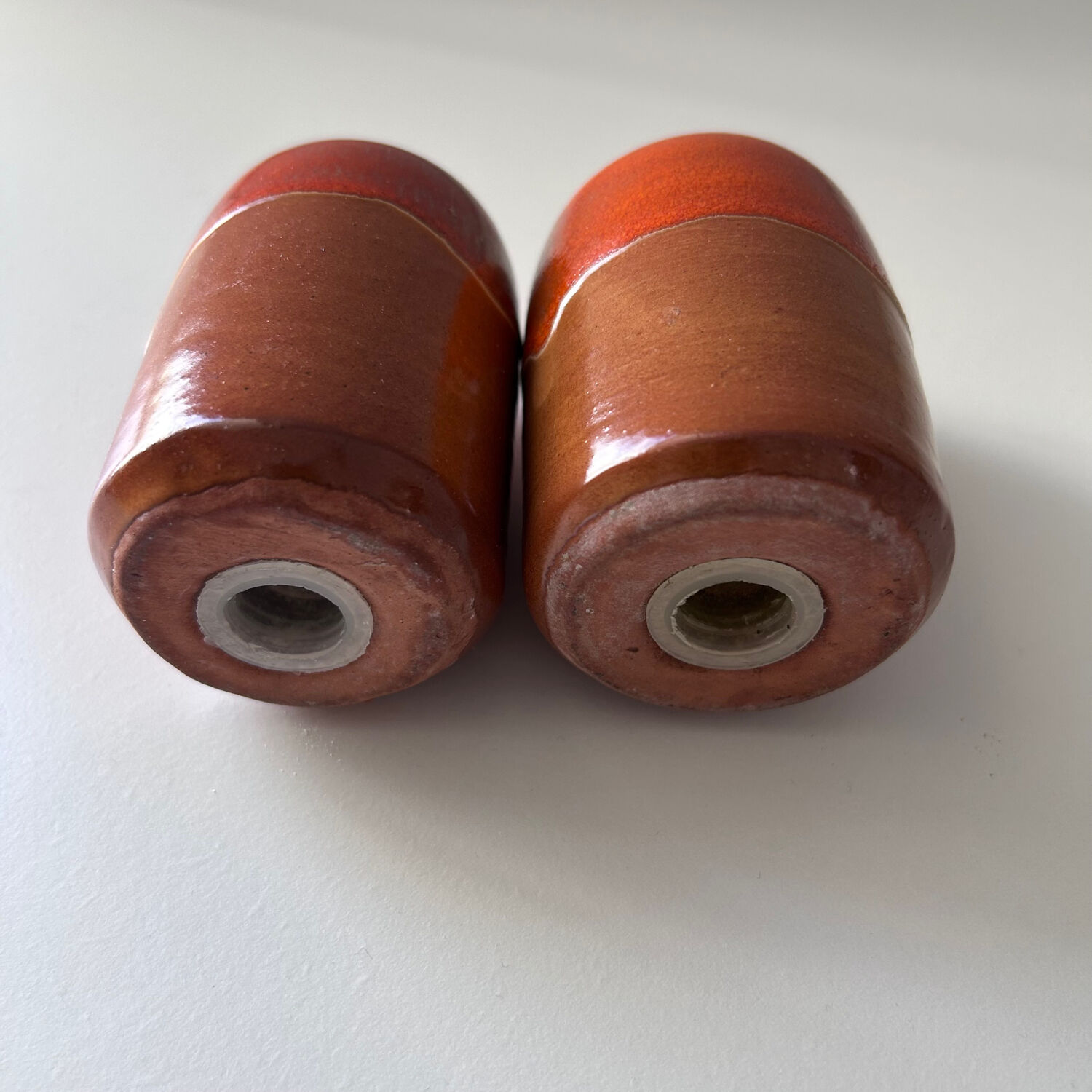 Salt and pepper shakers in orange stoneware