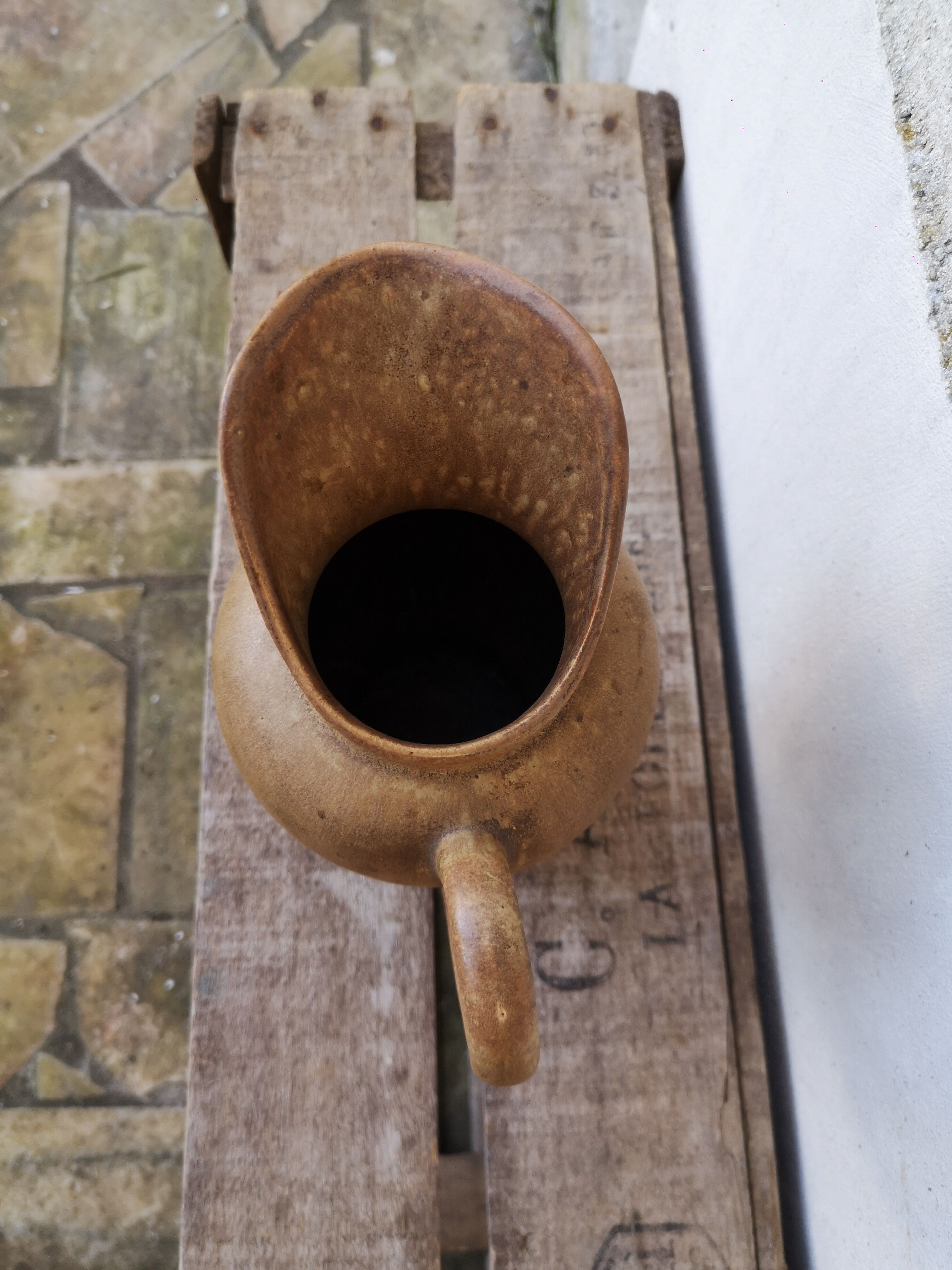 Pitcher in brown sandstone