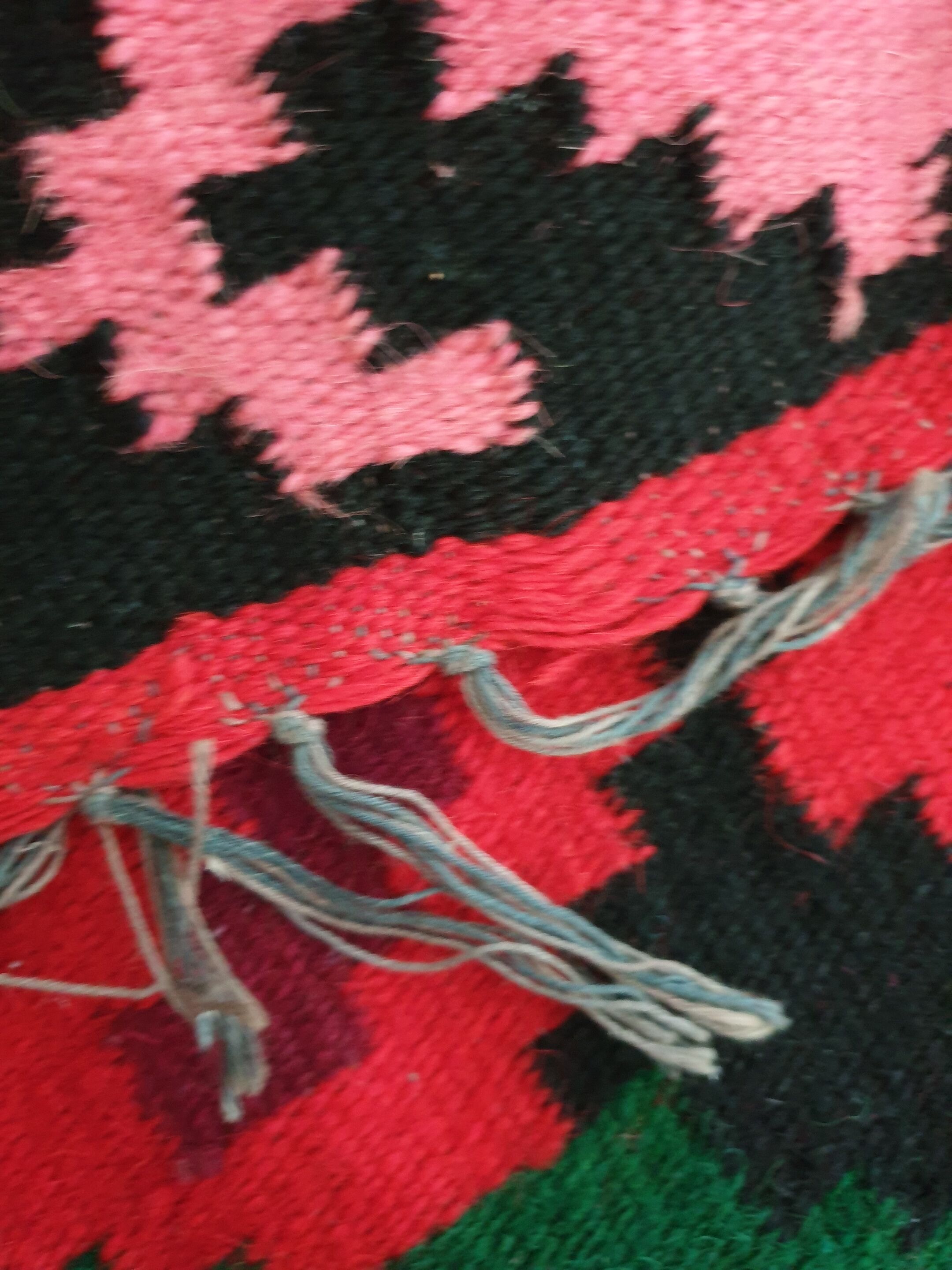 Colorful kilim on black background with floral design