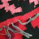 Colorful kilim on black background with floral design
