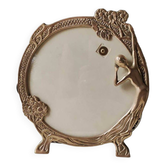 Old art nouveau style round photo frame. young woman at the mirror. in golden patinated brass 25.5 x 23 cm