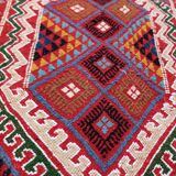 Red carpet with multicolored Berber patterns woven with hands