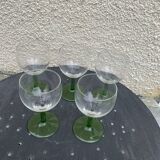 5 transparent glass glasses and green glass vase go