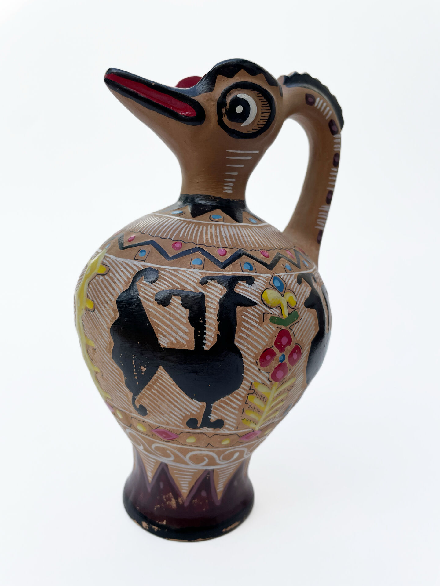 Clay pitcher with a bird head