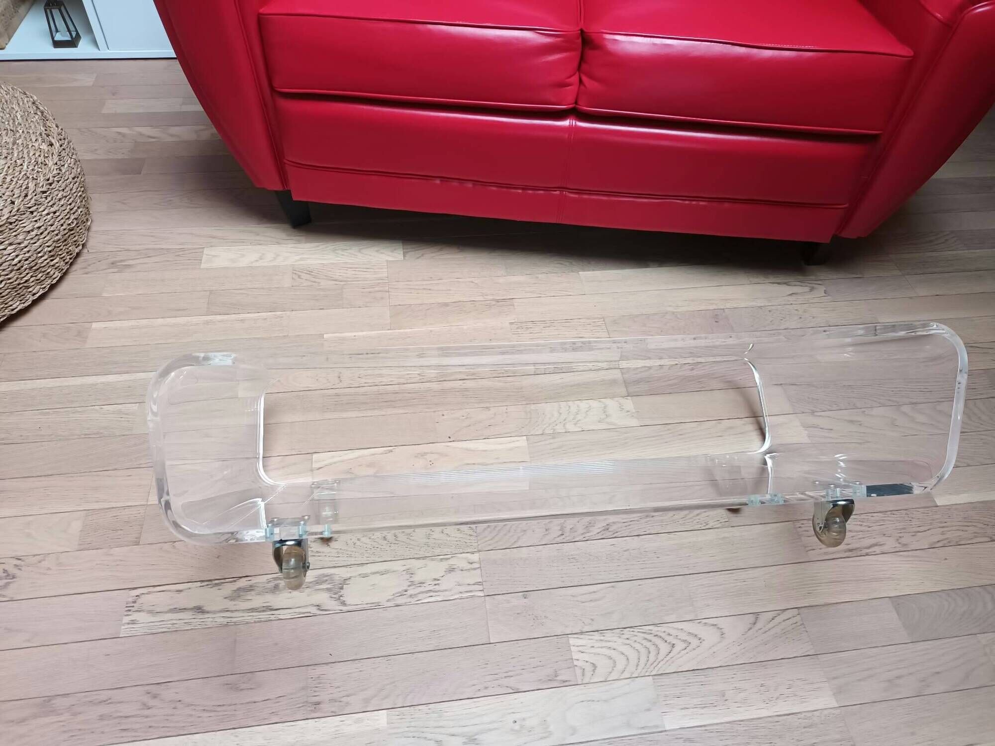 Design coffee table from Habitat in transparent plexiglass, mounted on wheels.