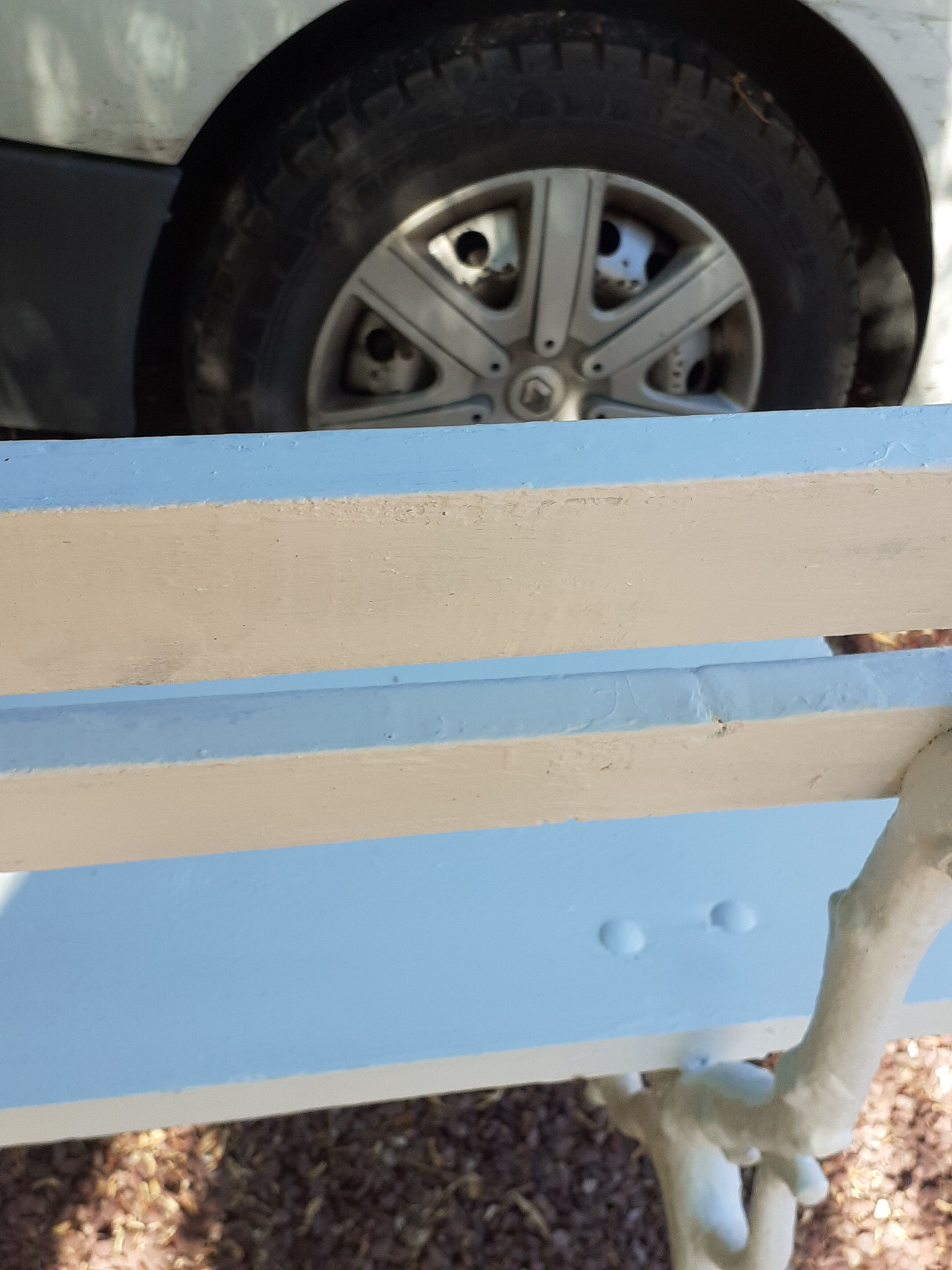 Old garden bench with cast iron feet and wooden planks