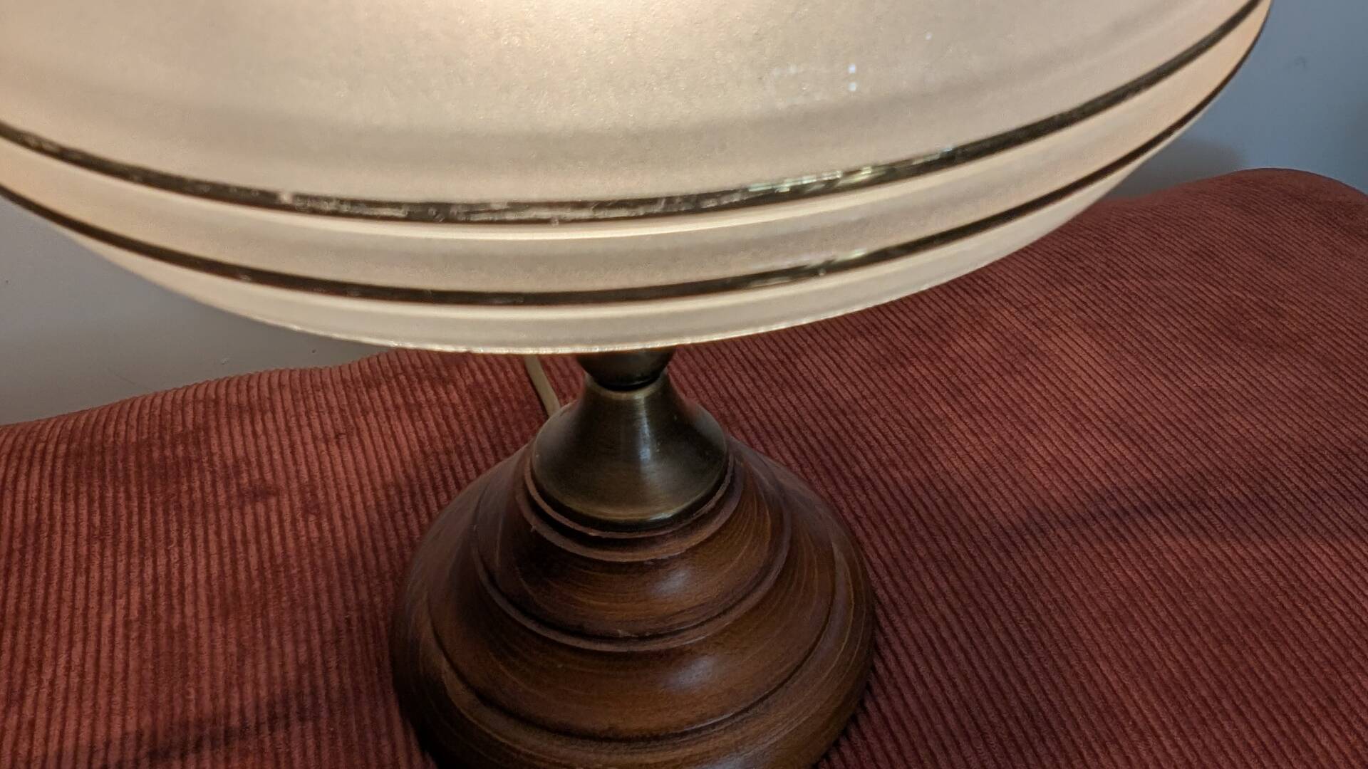 Vintage lamp made of turned wood, brass, and frosted glass.