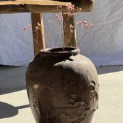 Large traditional Indonesian clay pot featuring a dragon.