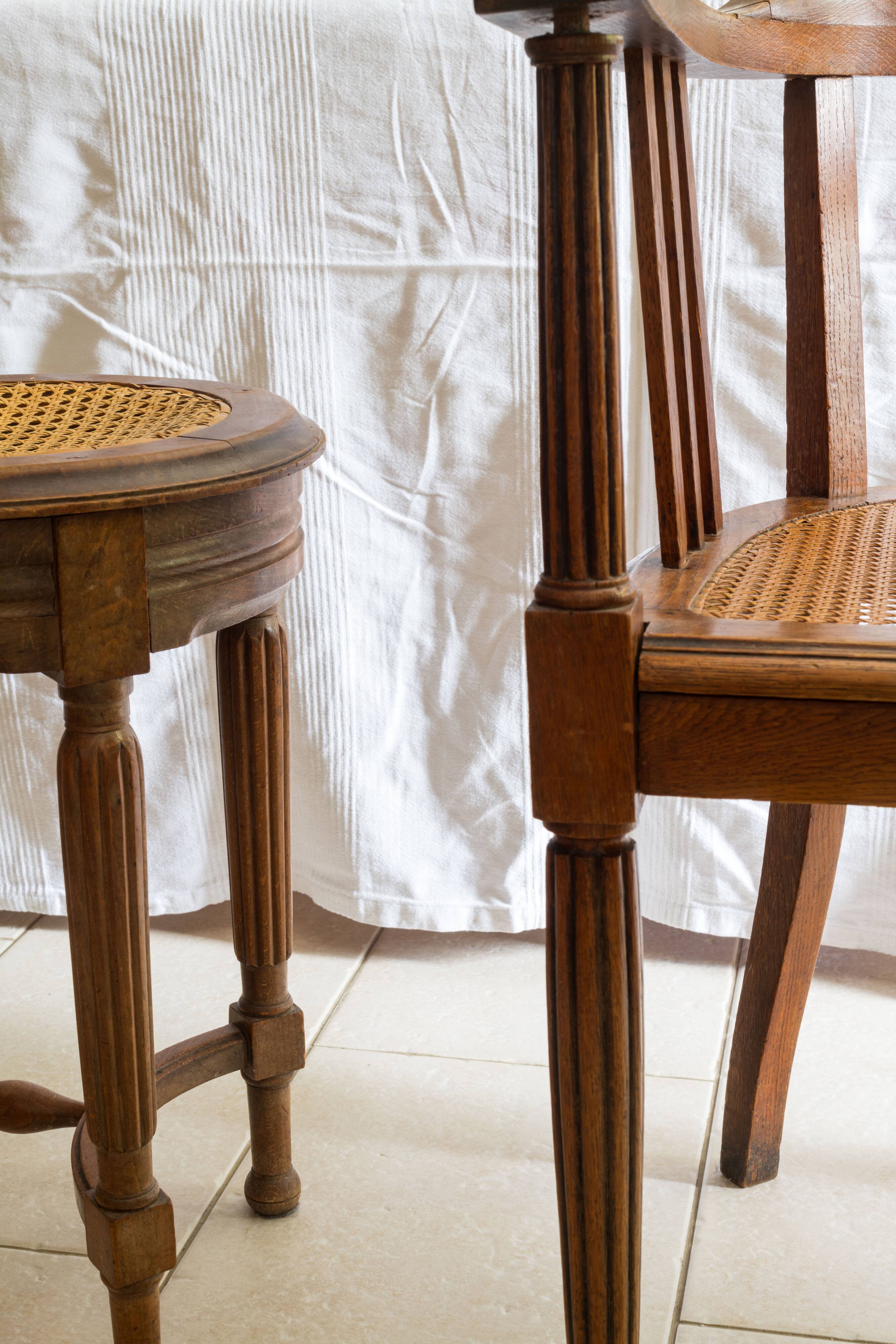 Antique armchair and stool with caned seat and fluted legs