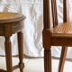 Antique armchair and stool with caned seat and fluted legs