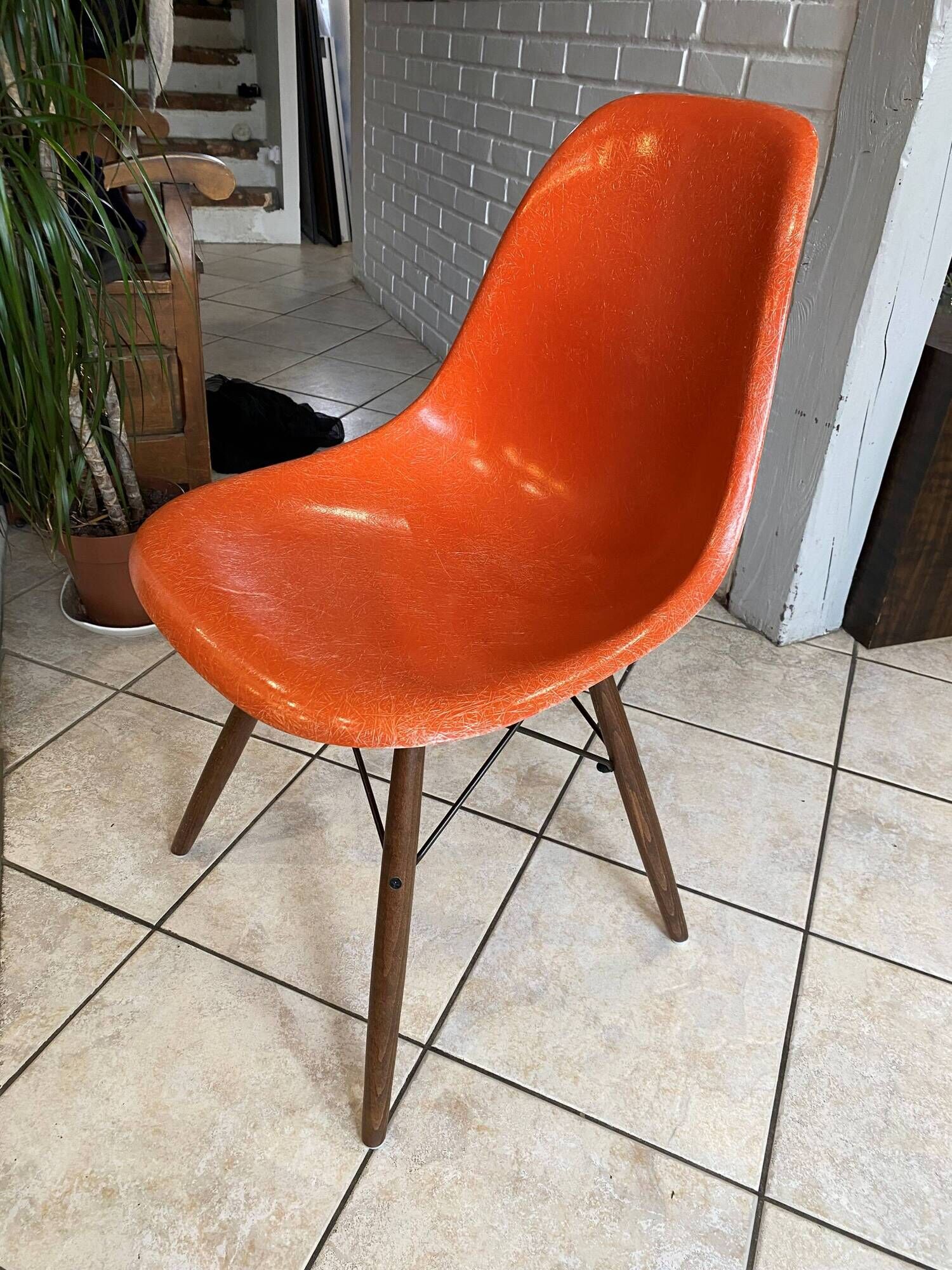A vintage 70s Eames Herman Miller DSW Fiber Red Orange Dowel Walnut Chair