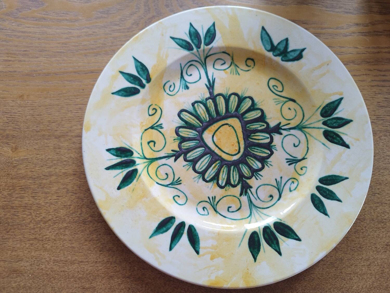 Plate decorated with yellow and green flower, signed Kerbigot.