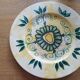 Plate decorated with yellow and green flower, signed Kerbigot.