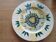 Plate decorated with yellow and green flower, signed Kerbigot.