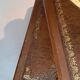 Library spiral staircase in beech and brown leather.