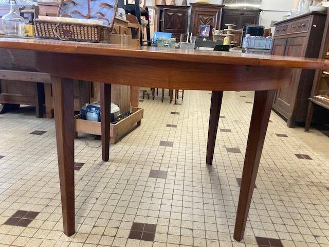 Round wooden table with integrated extensions