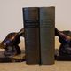 Art Deco pair of bookends with stylised fish in patinated metal and marble.