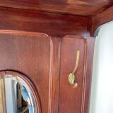 Antique wooden coat rack with mirror and shelf.