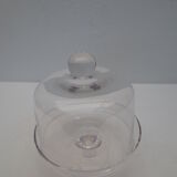 Old bell with cakes on glass stand