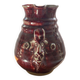 Oxblood pitcher with grotesque mask in the Delplera spirit