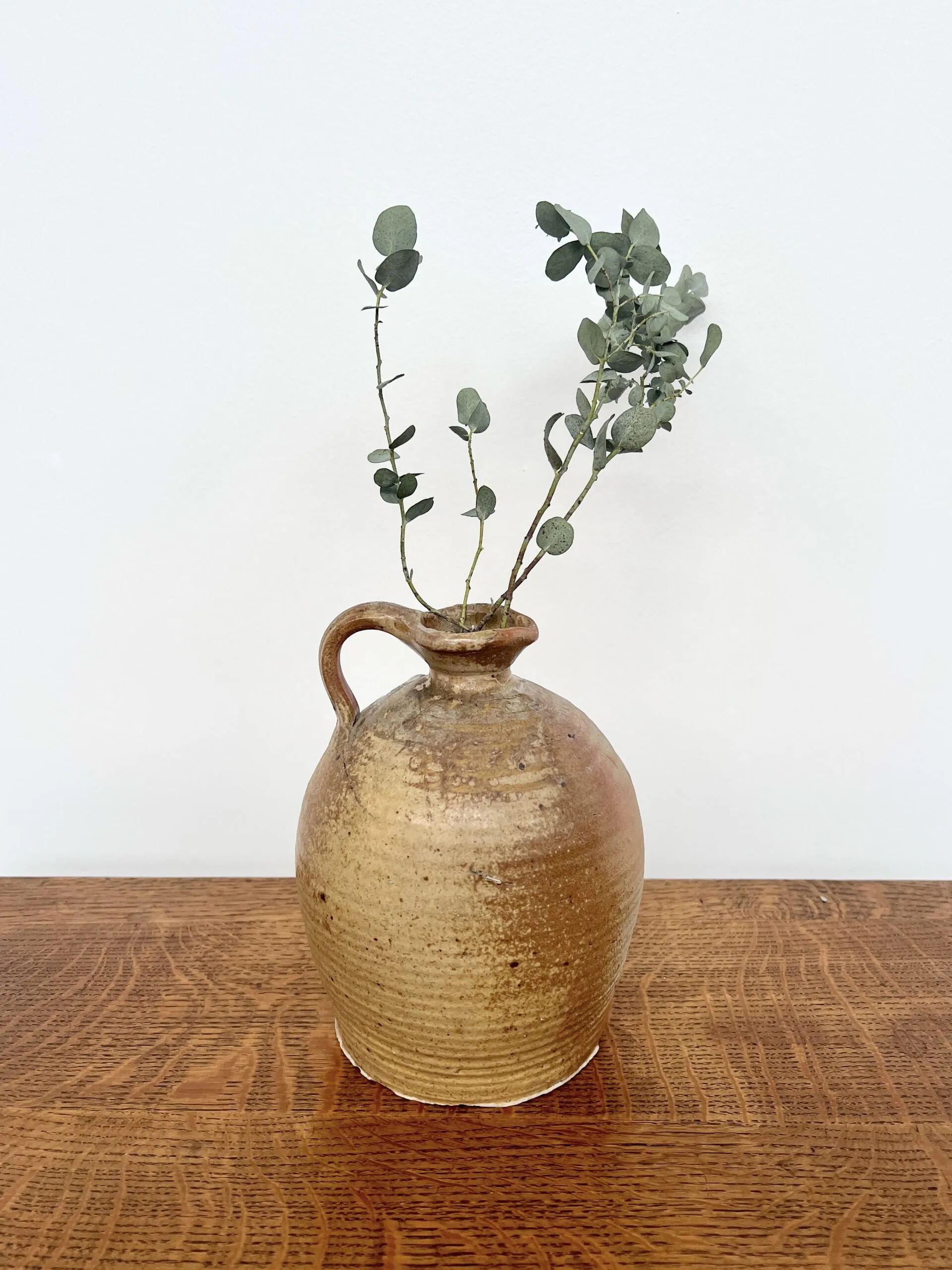 Small antique stoneware jar with handle
