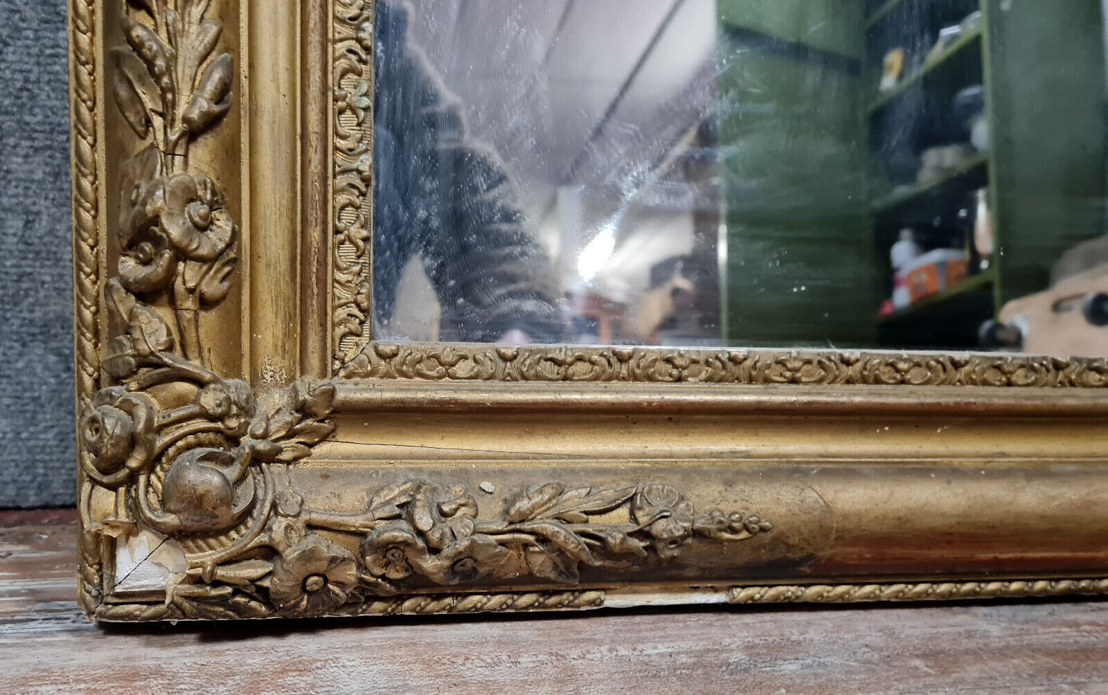 Old nineteenth century mirror in gilded wood and carved around 1850