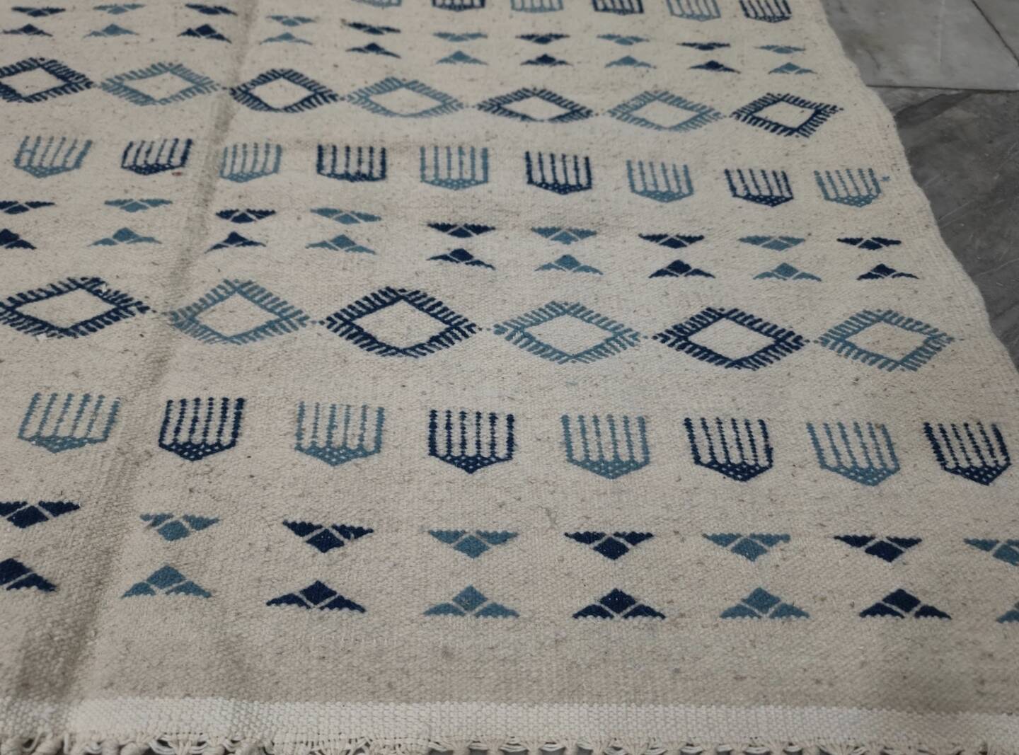 Handmade white and blue rug made of natural wool