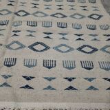 Handmade white and blue rug made of natural wool