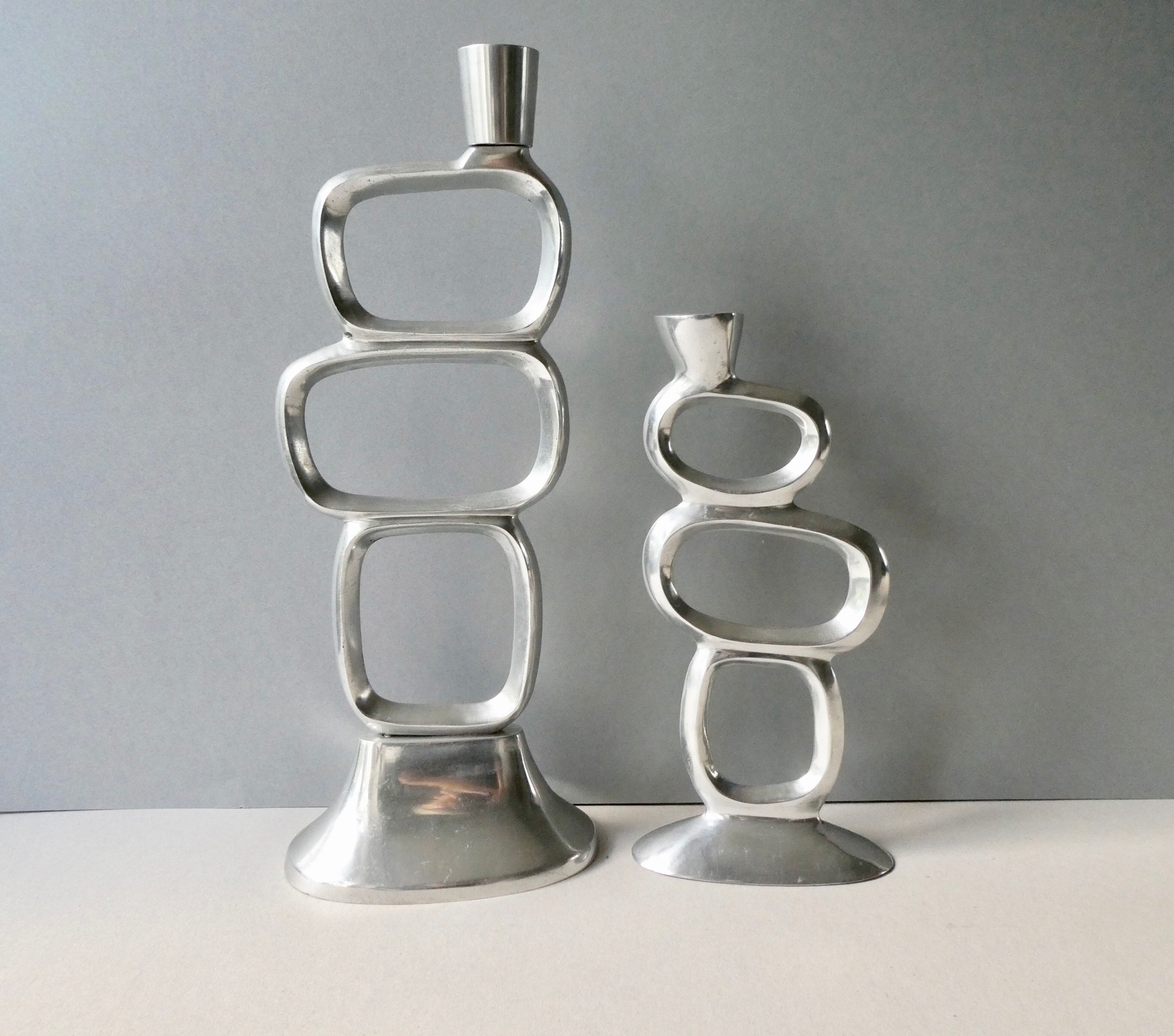 Pair of cast aluminum candle holders, design