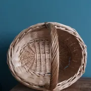 Handcrafted wicker basket with a handle.