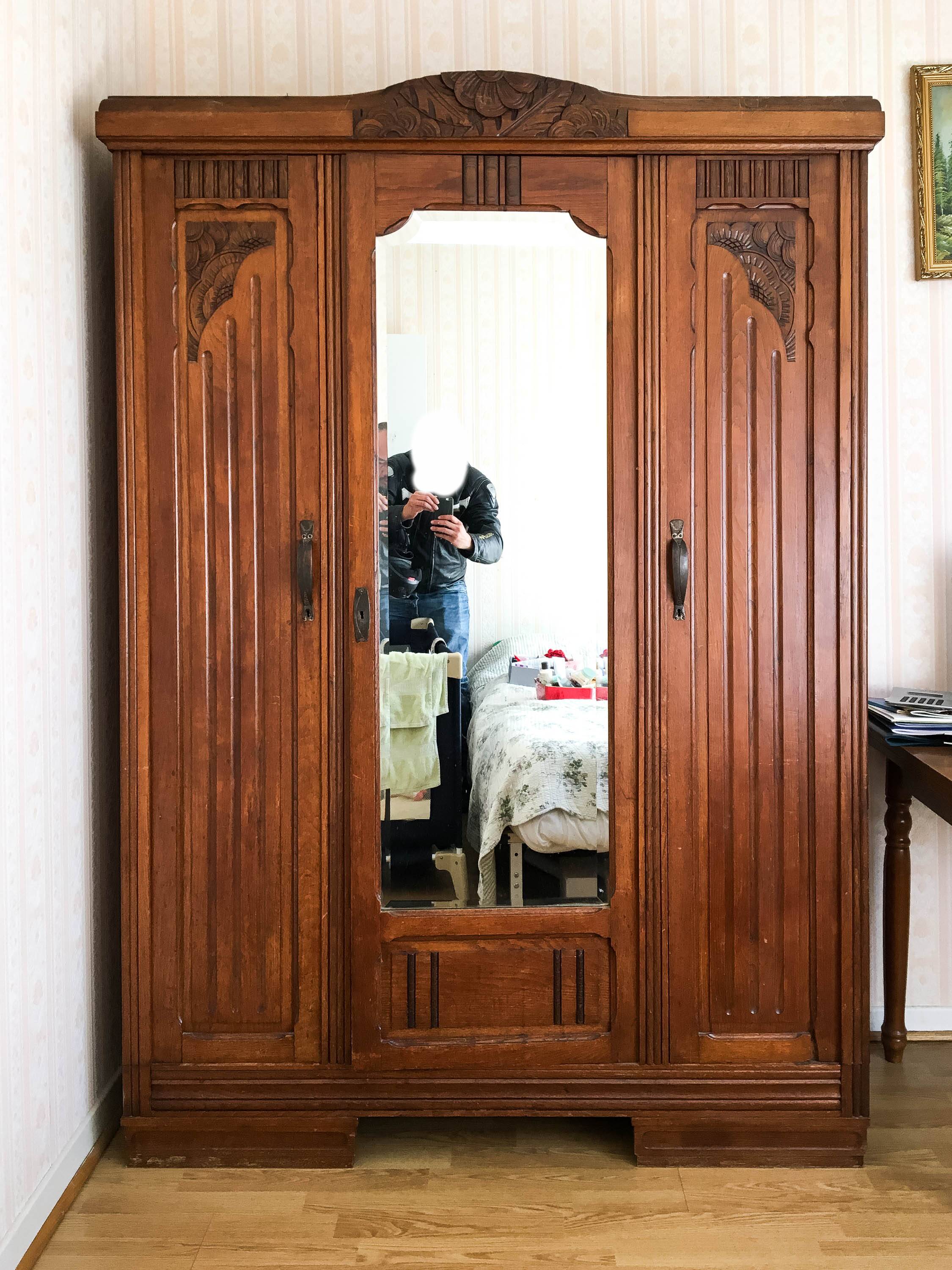 Old solid wood wardrobe with three vintage mirror doors