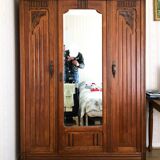 Old solid wood wardrobe with three vintage mirror doors