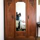Old solid wood wardrobe with three vintage mirror doors