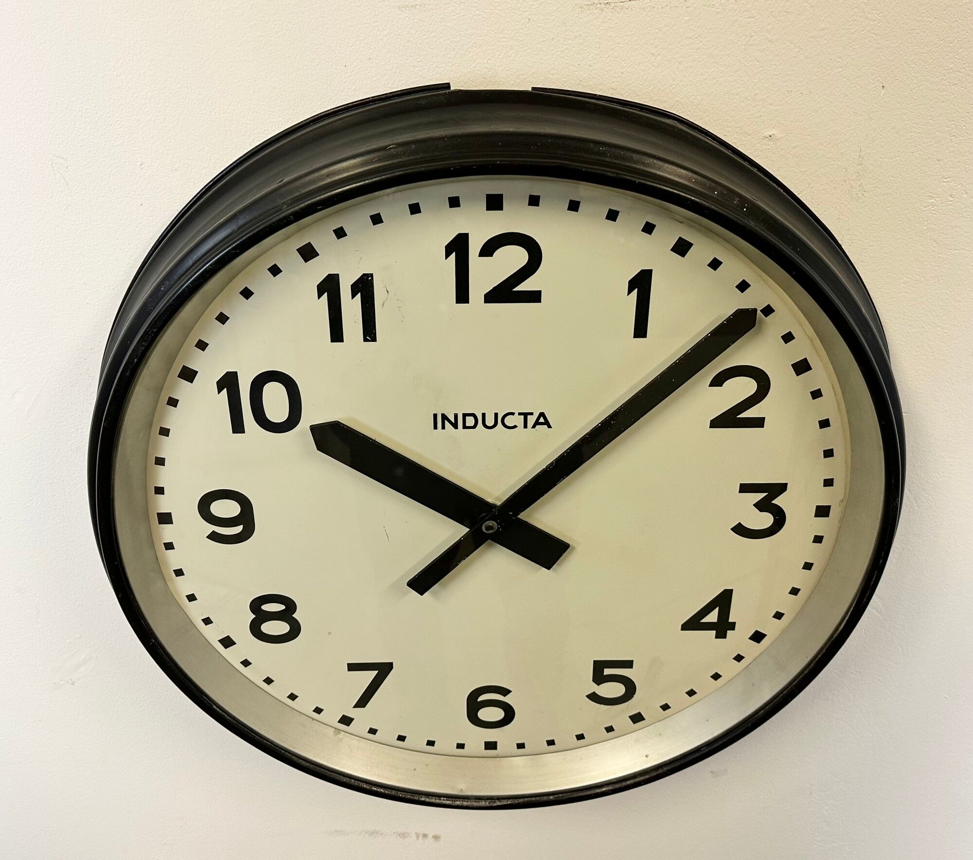 Black swiss industrial wall clock from inducta, 1960s