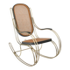 Modernist rocking chair in gilded brass and cane.