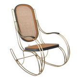 Modernist rocking chair in gilded brass and cane.