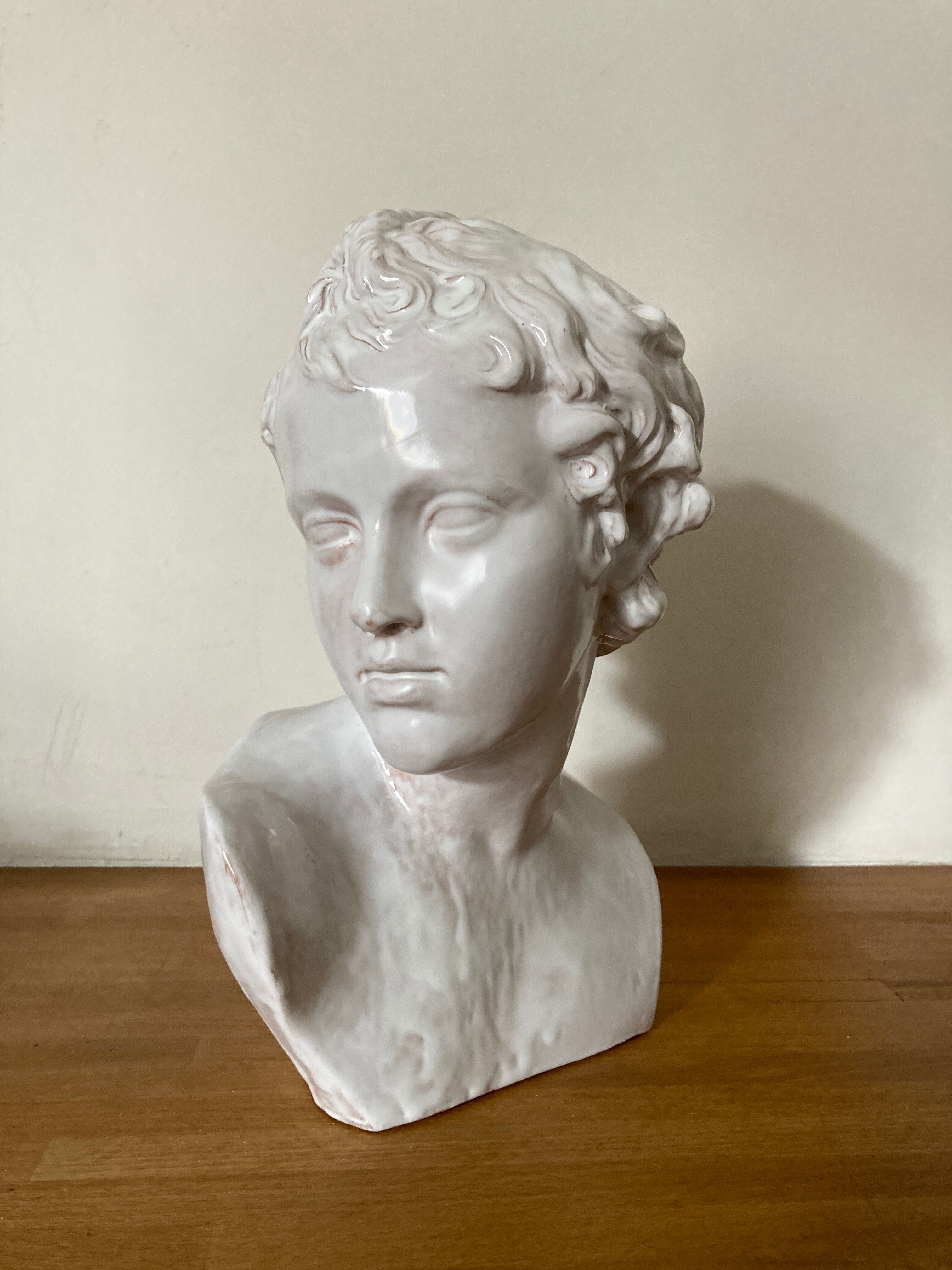 White enamelled terracotta Eros bust