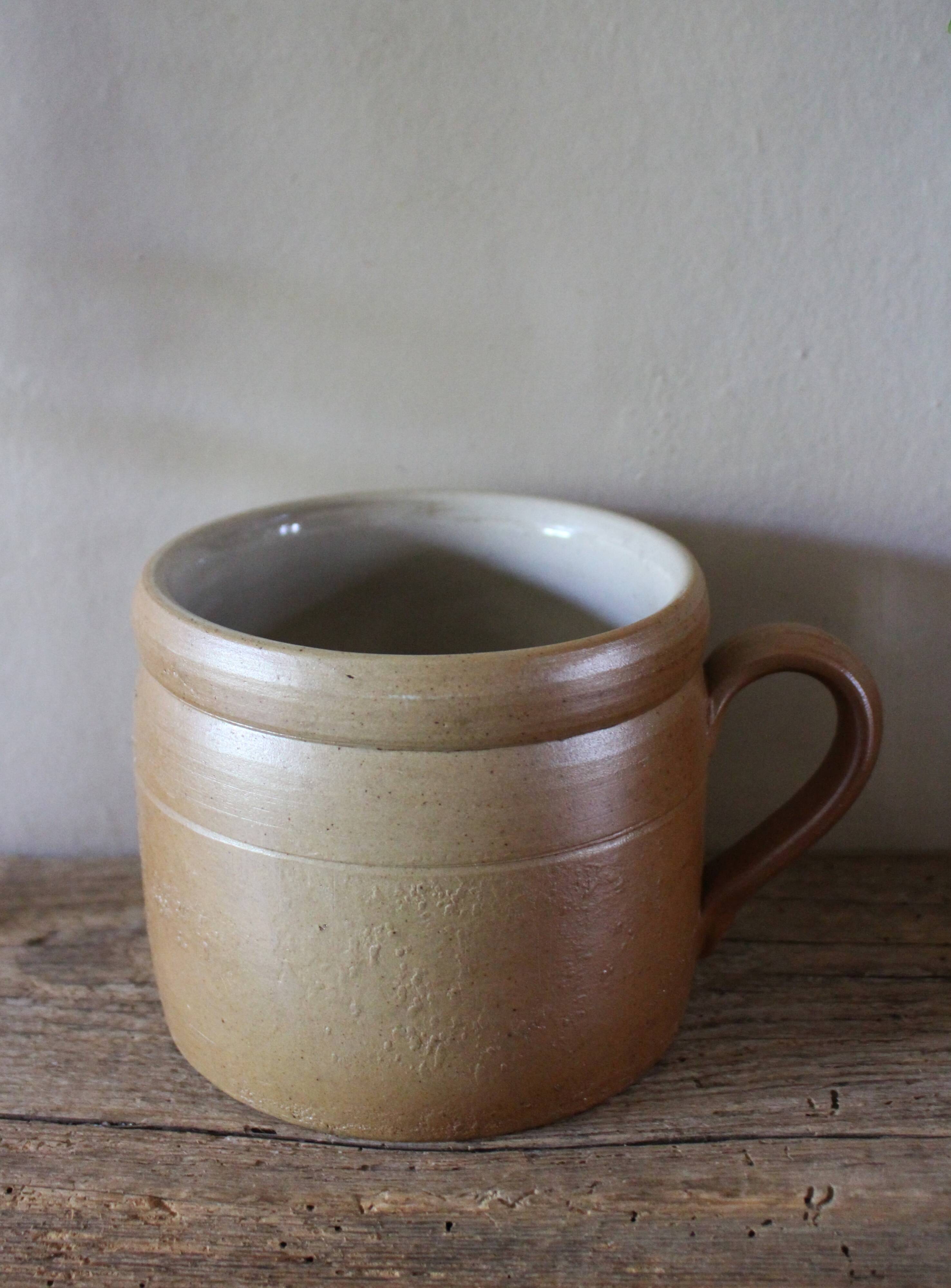 Vase terracotta milk jug with a glazed interior handle.