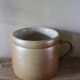 Vase terracotta milk jug with a glazed interior handle.