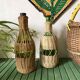Glass bottles and woven rattan