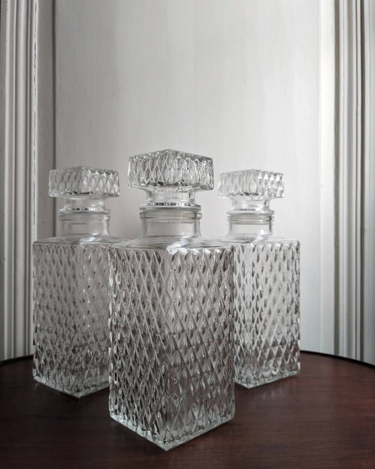 3 diamond-patterned chiseled glass carafes