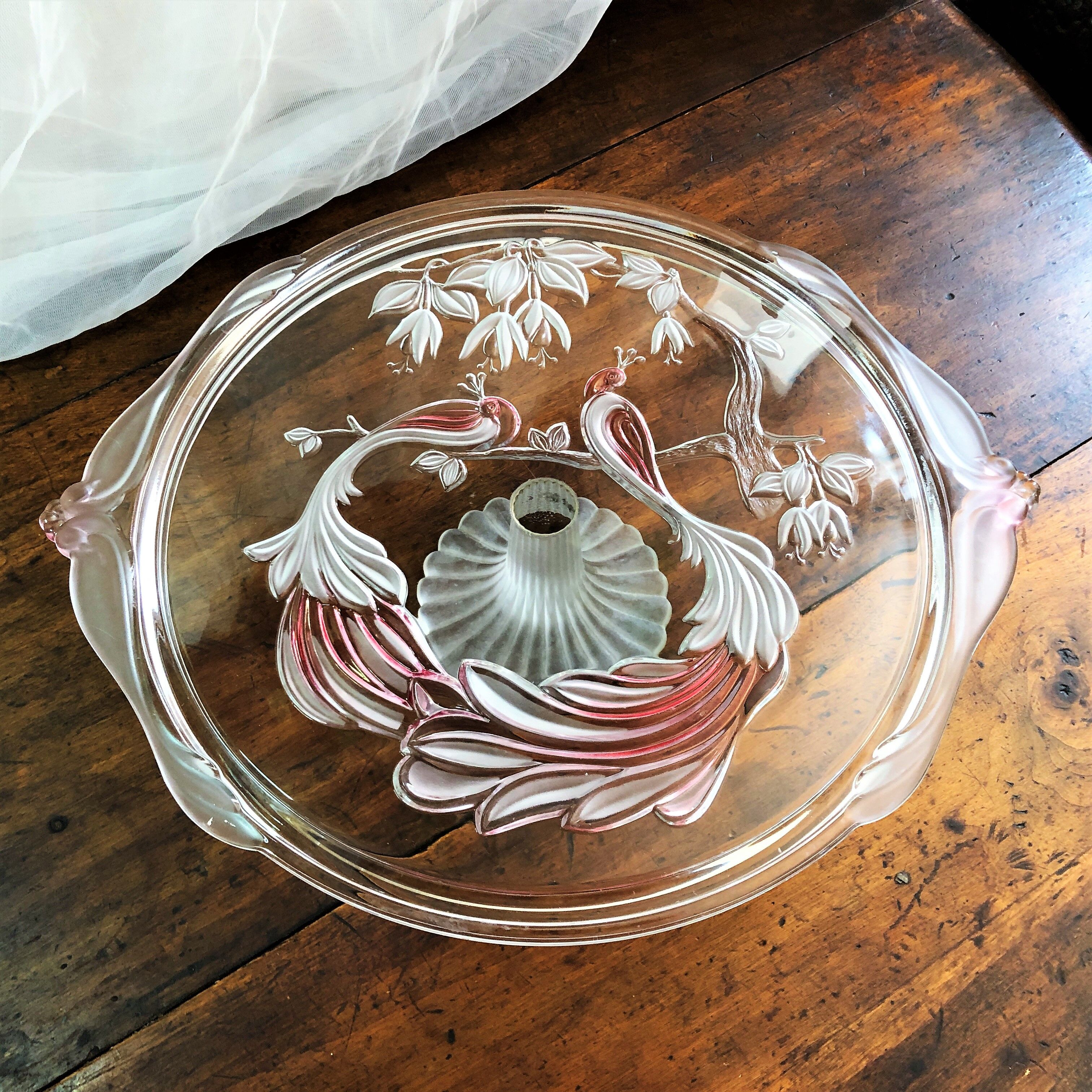 Large pie dish cakes on pedestal decorated with peacocks