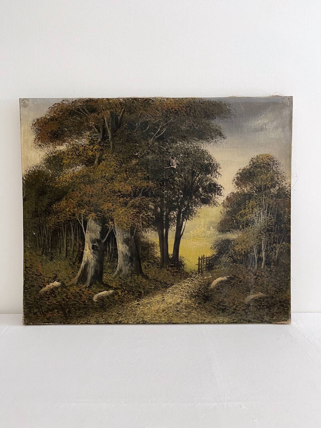 Old oil painting on canvas of a forest landscape.