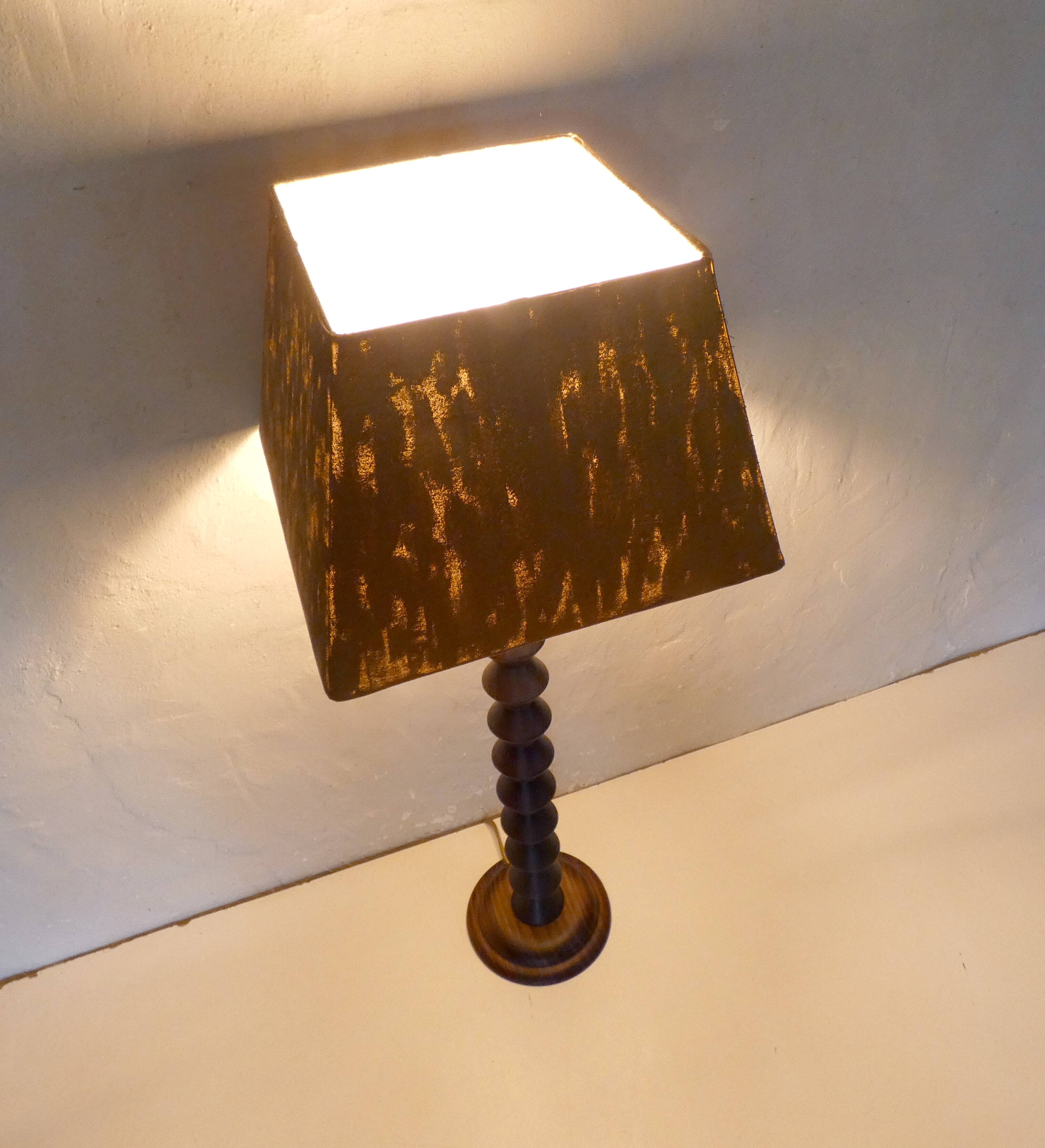 turned wooden lamp with spool base and vintage copper shade